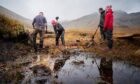 CARBON SINK: John Muir Trust volunteers work on peat bog restoration at Glen Nevis.