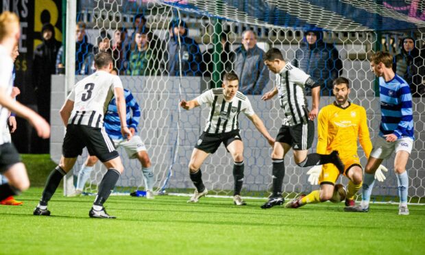 A header from Fraserburgh's Bryan Hay, number three, creeps through the legs of Banks o' Dee goalkeeper Andrew Shearer