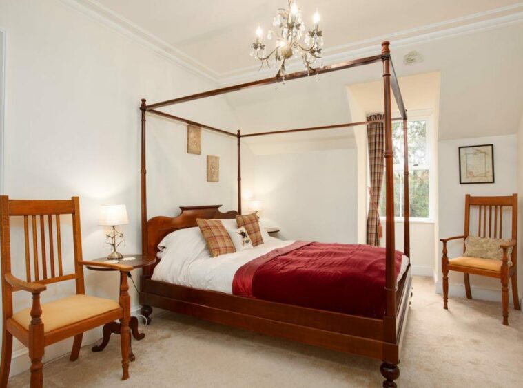 A bedroom with a four-poster double bed
