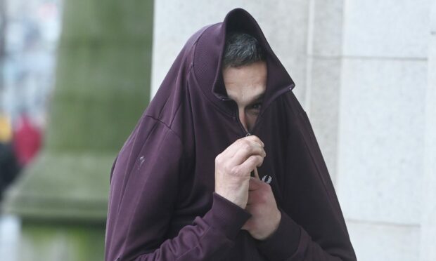 Camera-shy Daniel Weir covered up outside Aberdeen Sheriff Court.