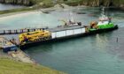 The barge carrying the first module that will make up the new Fair Isle bird observatory arrives on the island. Image: Douglas Barr/FIBOT.