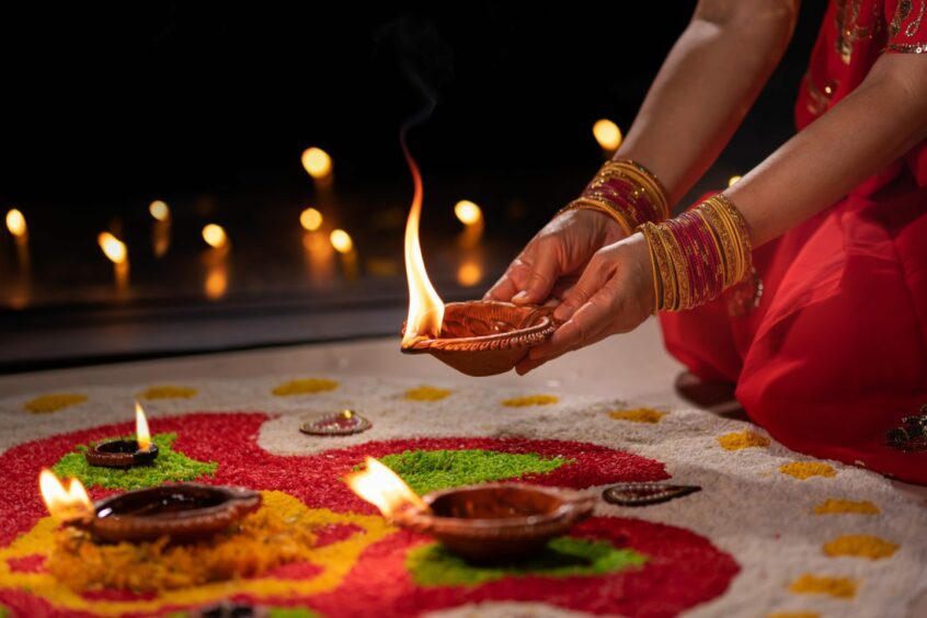 Traditional lamps lit during Diwali celebration.