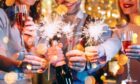 Christmas Day dinner celebrations with glasses of fizz and sparklers