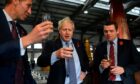 Diago global production director Ewan Andrew with former Prime Minister Boris Johnson and Douglas Ross MP at Diageo's Roseisle Distillery where they are standing together drinking whisky. Photo by Daniel Leal-Olivas