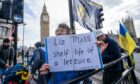 A protester holds a sign outside Parliament predicting Liz Truss's brief stint as PM. Picture: Amer Ghazzal/Shutterstock.