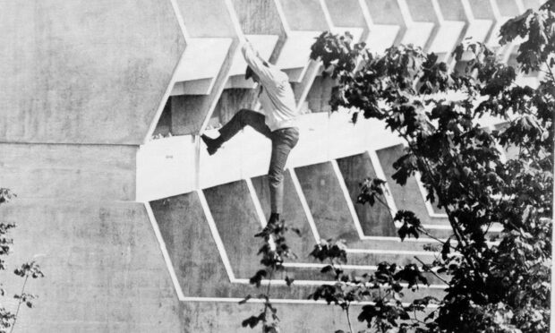 A member of the Hong Kong team jumps from the balcony of his apartment at the Olympic Village to escape the attack. Photo: Uncredited/AP/Shutterstock.