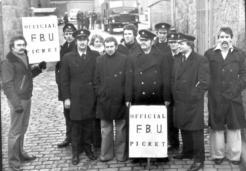Aberdeen firemen standing outside with signs reading "Official F.B.U Picket"