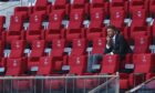 A lonely-looking David Beckham looks on from the stands at the England v Iran game on Monday. Image: Kieran McManus/Shutterstock.