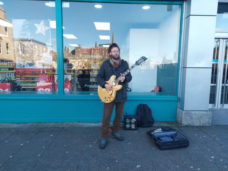 Mark Grundy performs outside Poundland on Union Street