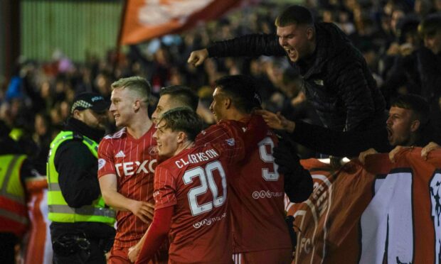 Aberdeen's Ylber Ramadani celebrates with fans in the Red Shed after scoring to make it 3-0 against Hibernian.