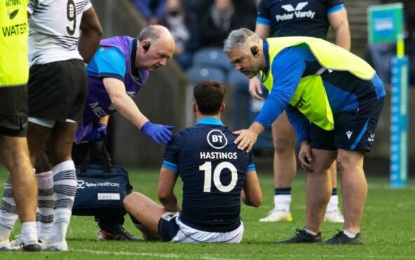 Adam Hastings gets treatment afer taking a heavy hit at Murrayfield.