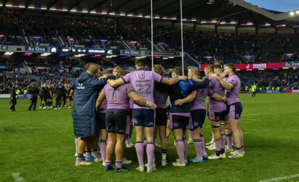 The Scots huddle in disappointment after the loss at Murrayfield.