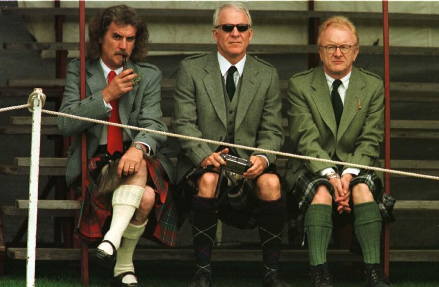 Billy Connolly and Steve Martin watching the Lonach Highland Games