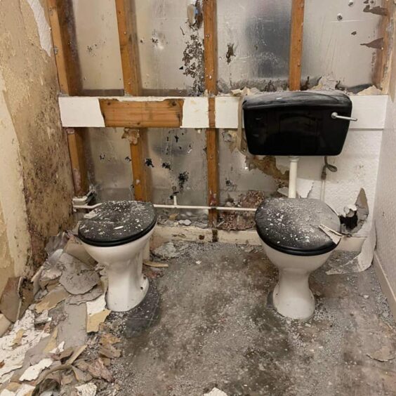 Wrecked bathroom inside the Highlander Hotel before its transformation.