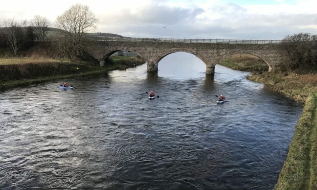 Specially trained police searching the River Don yesterday. Image: Police Scotland.