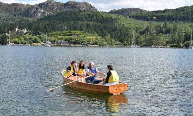 Boat builder Mark Stockl and Plockton high pupils on Eilidh's maiden voyage. Image: Plockton High School