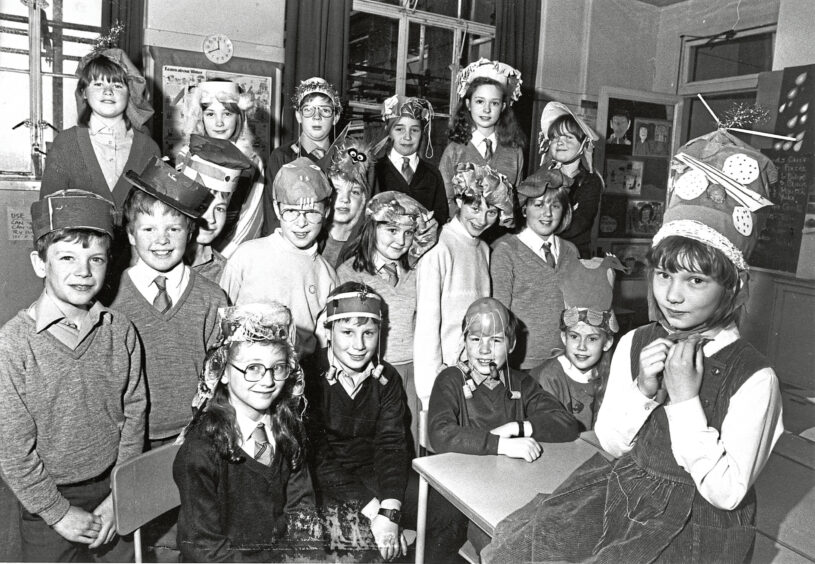 A class of pupils wearing homemade Easter hats.