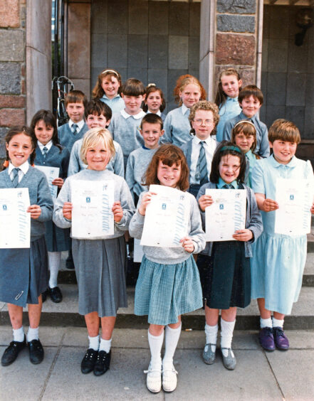 A group of pupils holding up certificates