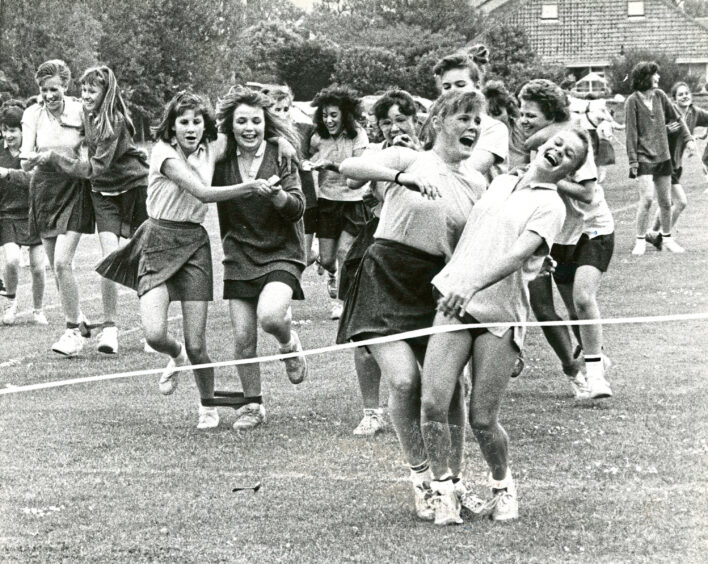 Girls racing with eggs on spoons at St Margaret's school for girls sports day