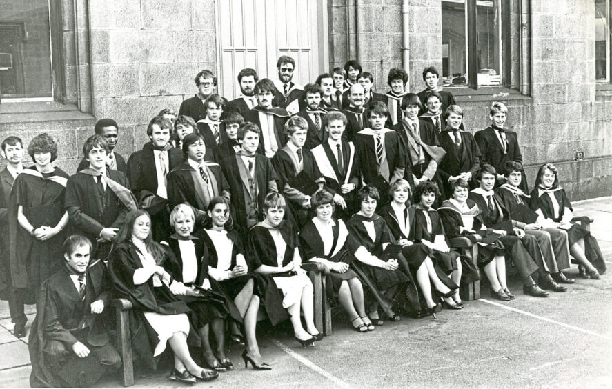 A group of graduates sat in rows from their photo