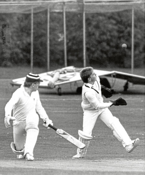 1987 - Aberdeenshire wicketkeeper Raymond Pirie in action during a match against Grades at Mannofield.
