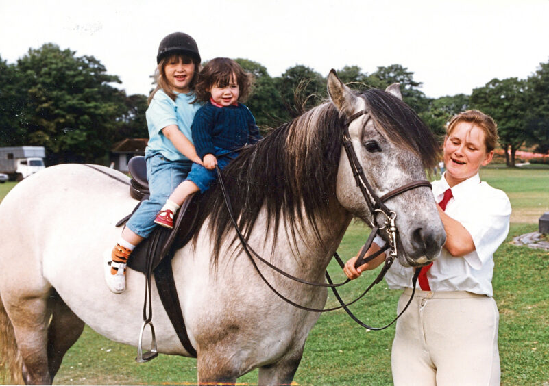 1991 - Karen Thomson keeps a firm grip of the reigns of Tam of Litigan as Felicity Ibbotson, 4, and sister Anna, 1, pose in the saddle at the North-east of Scotland Highland Pony Enthusiasts' Society Show