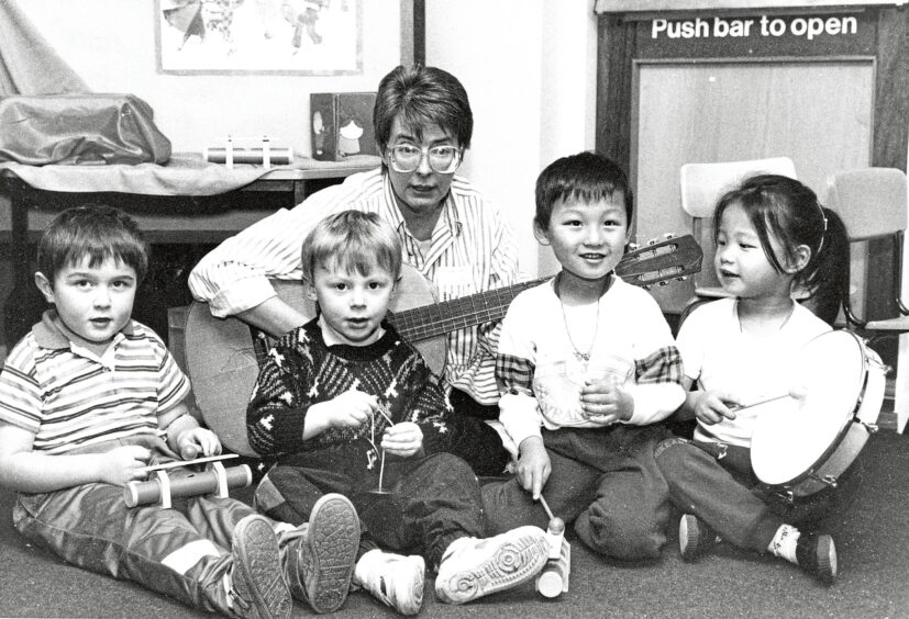 1992 - Neil Pirie, 4, Matthew McNaughton, 3, and twins Scott and Joanna Ng, 4, enjoy some music making at Glashieburn Nursery with Maureen Grant.