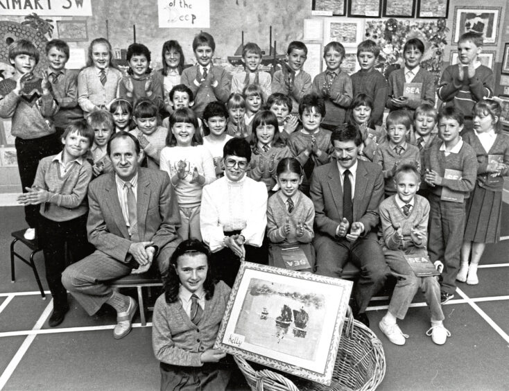 1987 - Kelly Mann of Primary 5 at the school gets a round of applause for her painting entitled Herring Drifters in the Sunset which was made ahead of the Aberdeen Fish Festival.