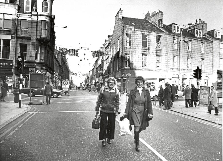 Two women walking along the pedestrianised street