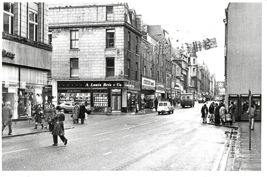 Shoppers waling across the street in Aberdeen