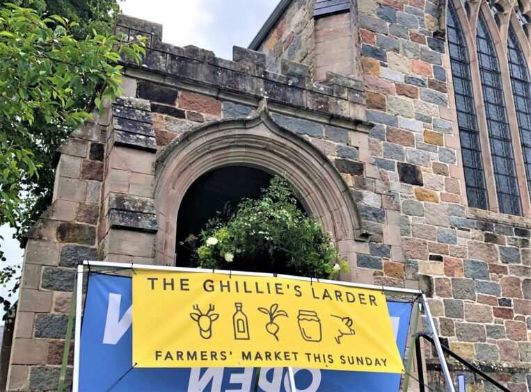 Sign for The Ghillie's Larder farmers' market in Braemar.