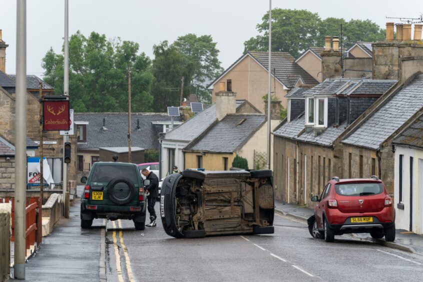 An overturned car on a main road out of Elgin which was blocked in this accident in 2021.