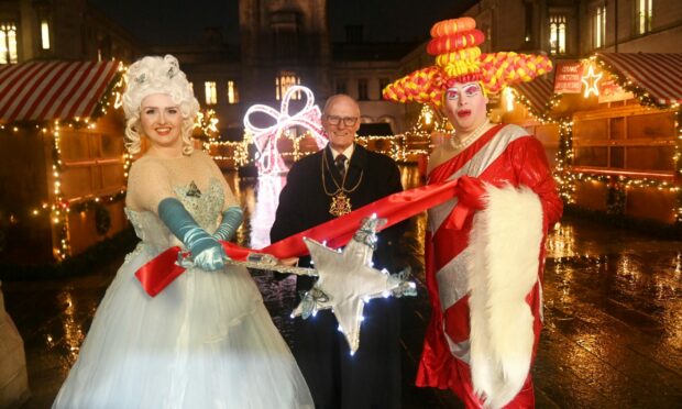 Megan Wright and Philip from the Aberdeen Arts Centre pantomime Cinderella are pictured with Lord Provost David Cameron at the opening. Image: Chris Sumner/ DC Thomson.