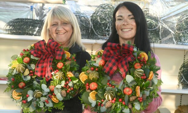 Carolann Topp and Gayle Ritchie show off their stunning autumn wreaths, made at Loch-hills Garden Centre. Picture: Chris Sumner.