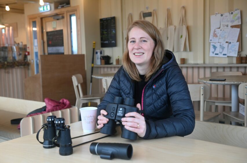 Fiona McIntyre holds a pair of binoculars at Greyhope Bay in Aberdeen.