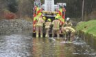 Firefighters pump water away from Kingsfield Road in Kintore. Image: Chris Sumner/DC Thomson

19/11/2022