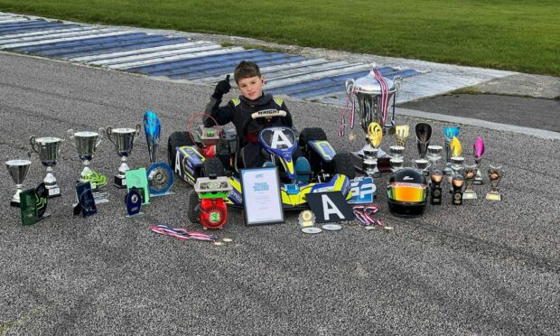 Cooper Earsman with his collection of go-karting trophies. Image: Supplied.