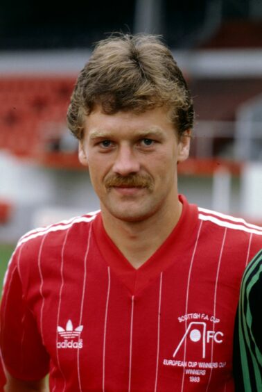 Picture of Aberdeen football player Dougie Bell, who has had two stents fitted. The picture, taken in the 1980s, shows a young Dougie Bell in his red and white Aberdeen FC football strip. He has a moustache and is looking directly at the camera. 