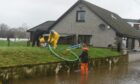 Residents on Kingsfield Road, Kintore, desperately tried to save their homes by pumping water away from the area. Image: Paul Glendell/DC Thomson