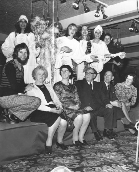 Bill Gibb surrounded by family, friends and models