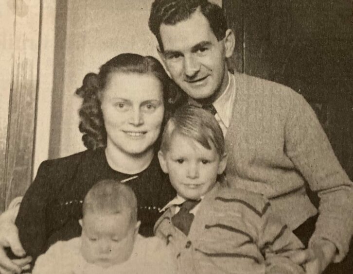 Ilse Collinson pictured with her husband Bill, holding children Sylvia and Brian, in a black and white image.