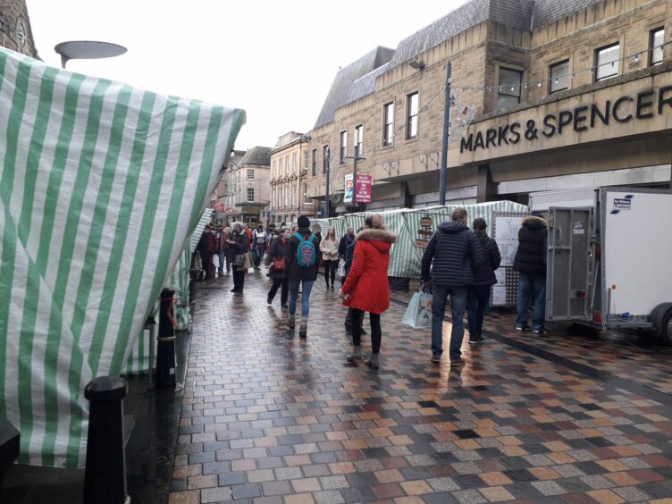 People walking at Inverness farmers' market.