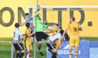 Forres goalkeeper Stuart Knight, in green, clears a corner under pressure from Fraserburgh's Paul Campbell