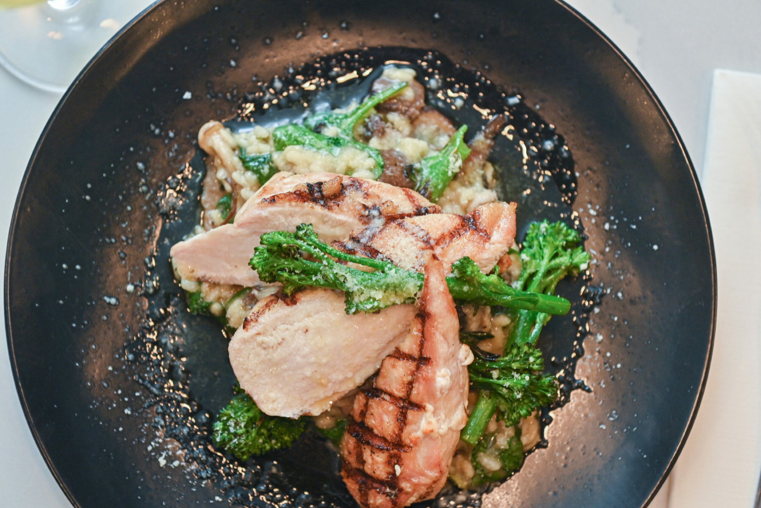 Grilled chicken, foraged mushroom risotto, spinach, and truffle dressing at The Drouthy Cobbler