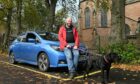 Reverend James Bissett, with his electric Nissan Leaf car in the Inverness Cathedral car park. .Image: Jason Hedges/DC Thomson.