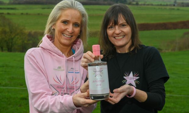Lauren Donald and Tammy Main with the new Abbie Sparkle gin. Image: Kenny Elrick / DC Thomson