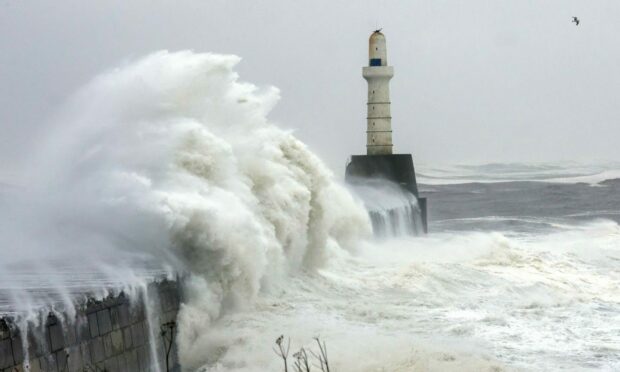 Crashing waves near lighthouse