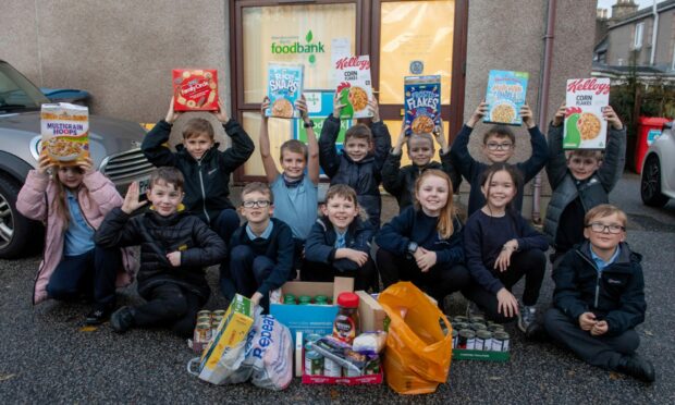 Strathburn Primary pupils as they drop off their donations. From left: Myrren Ainge, Scott Cameron, Freddie Faskin, Jack Barrie, Molly Barrie, Alicia Tarburn and Arron McKay; (Back) Cameron Mackay, Sebastion McAdie, Nathan Webster, Harry Hay, Finlay Low and Ethan Jenkins.