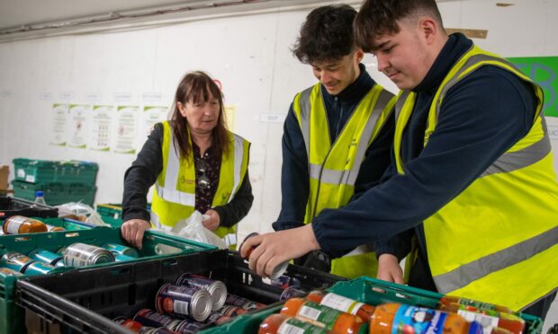 Volunteers packing emergency food parcels. Image: Kami Thomson / DC Thomson.