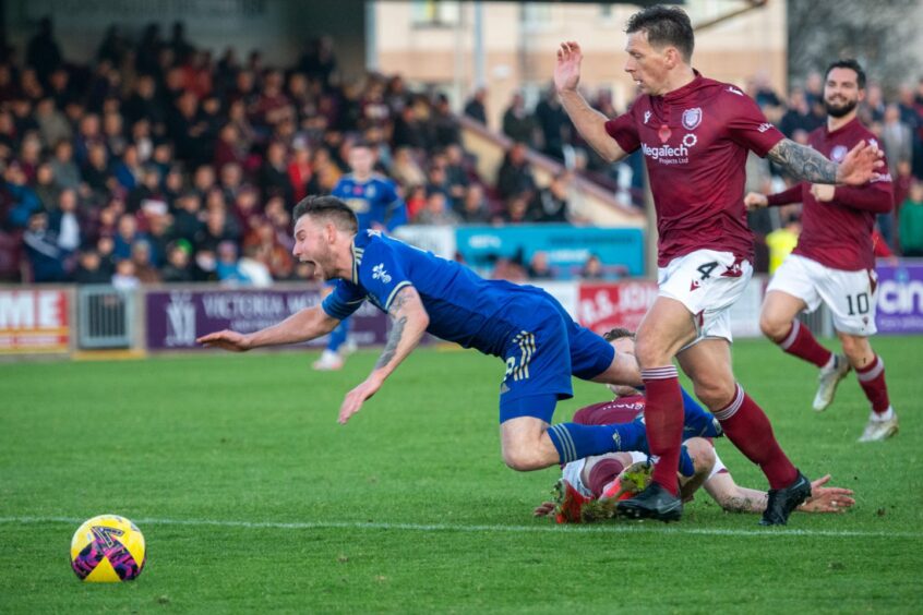 Mitch Megginson is felled by Thomas O'Brien in Cove Rangers' game with Arbroath. Image: Kami Thomson/DC Thomson